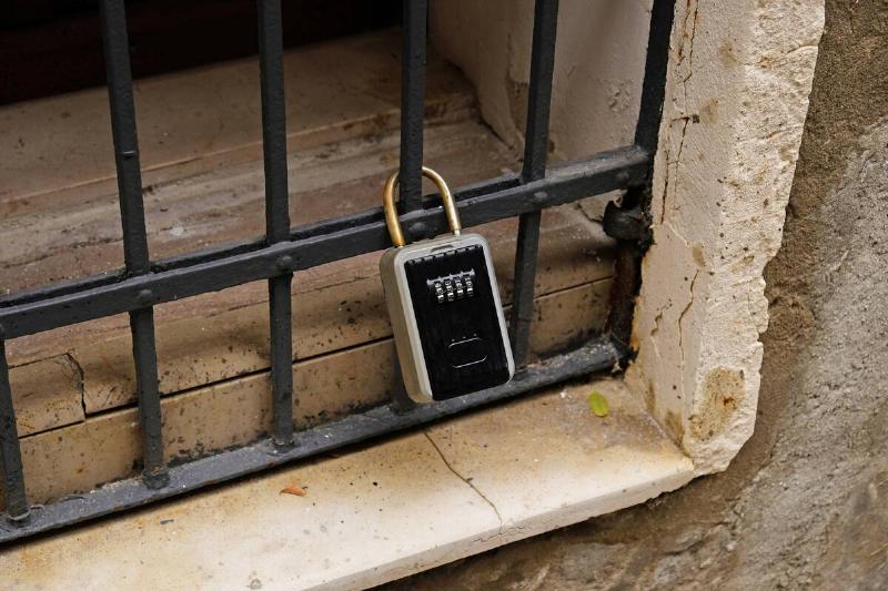 Smart lock box mounted on metal grate. 