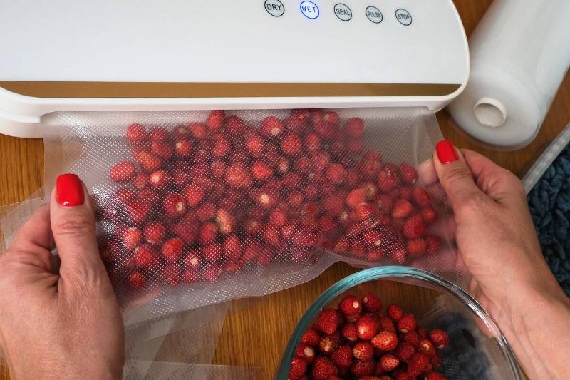 Vacuum sealer of strawberries, honeysuckle in bag