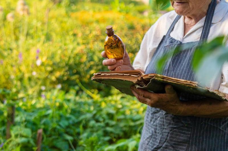 Gardener holding olive oil and book. 