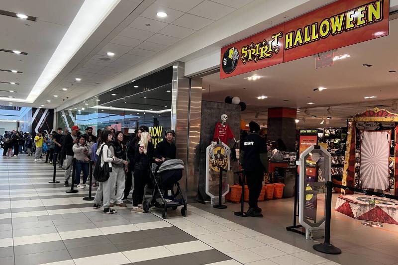 People waiting in line to shop at Spirit Halloween. 