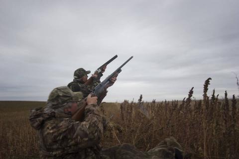 Two men duck hunting at dawn in North Dakota. 