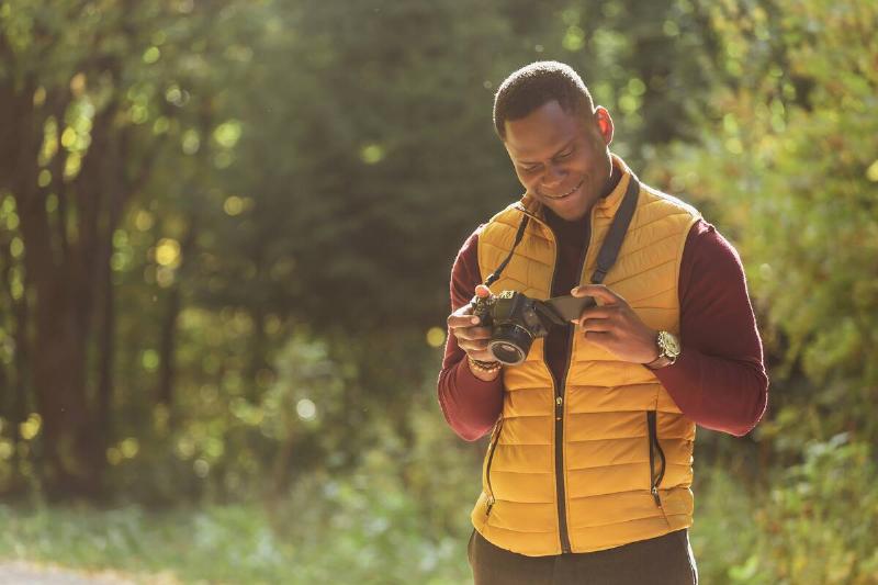 Man in puffer vest looking at camera.