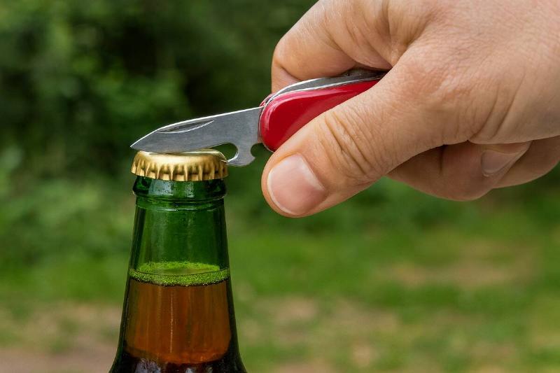 Using the bottle opener on a Swiss Army knife.