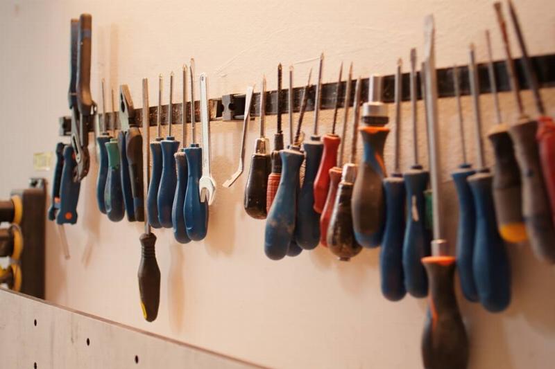 Different tools organized on a magnetic strip. 