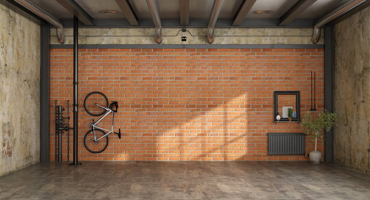 Garage with brick wall and wall-mounted bike rack. 