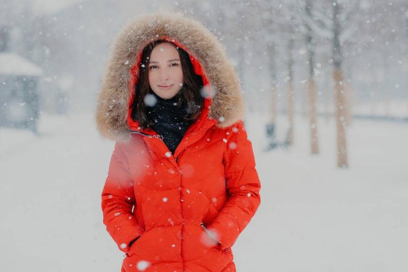 Female model in red winter jacket.