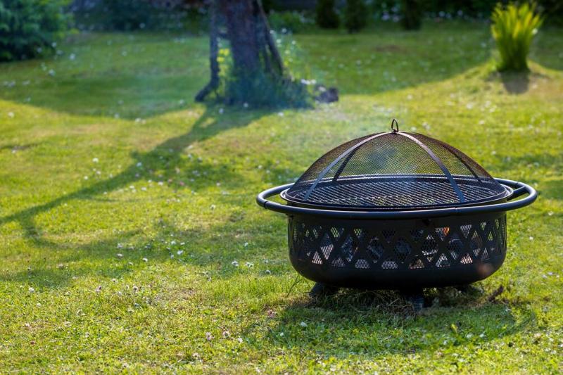 Fireplace with spark screen on grass. 