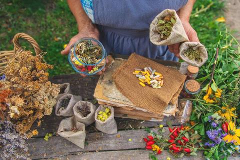 Woman holding plants and natural medicine. 