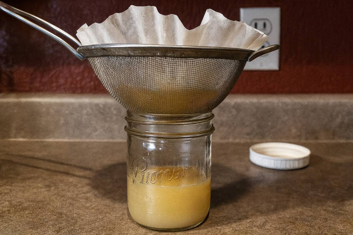 Coffee filter being used to strain grease.