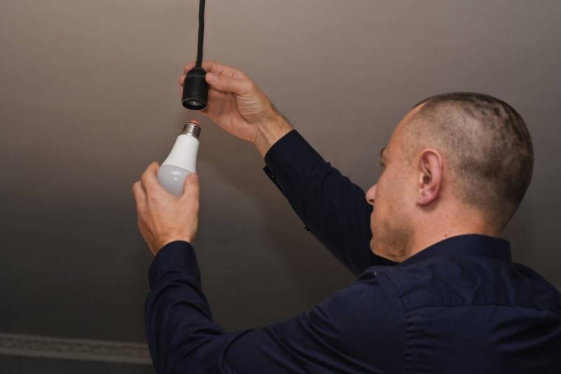 Man replacing lightbulb. 