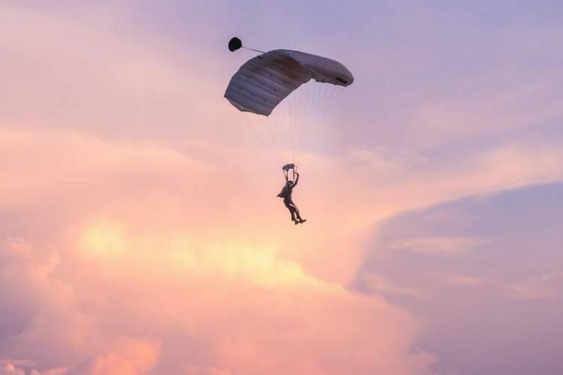 Skydiver in front of sunset. 