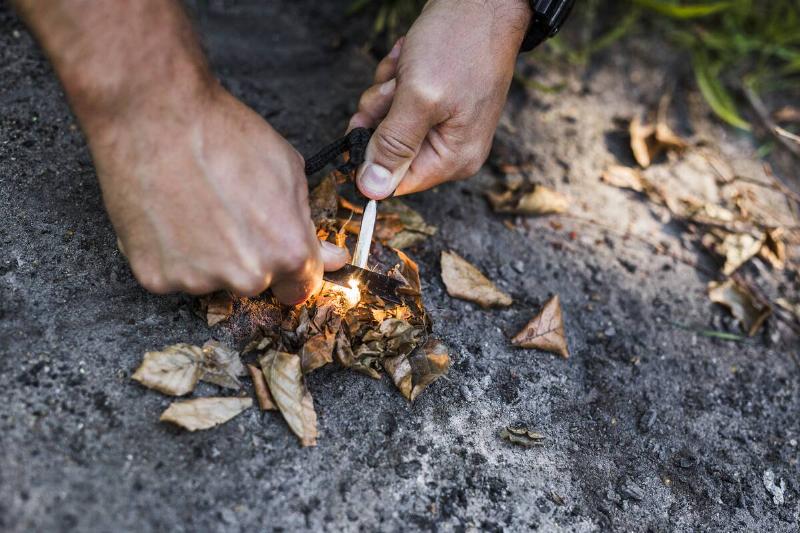 Using Swiss Army Knife to start a campfire. 
