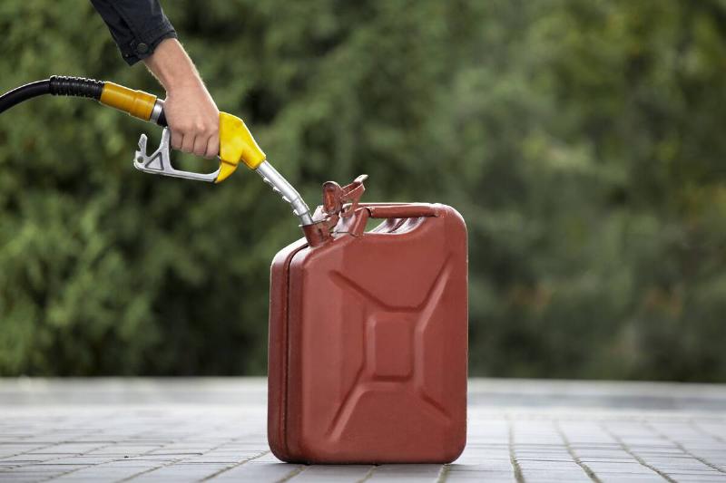 Can filling gasoline canister at gas pump. 
