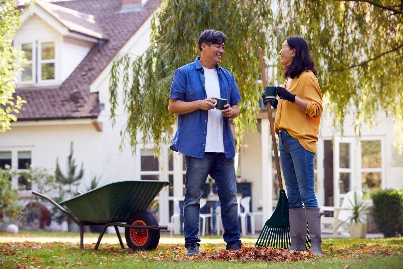 Two people drinking coffee and raking together. 
