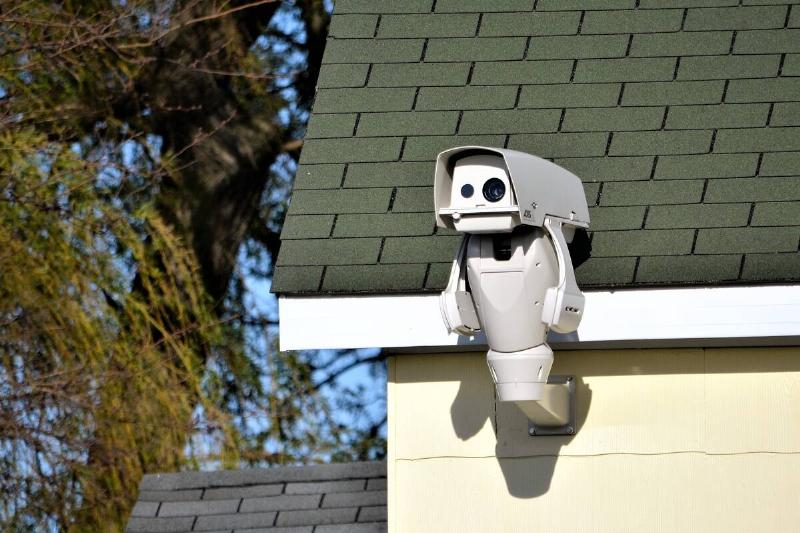 Modern security camera on house.