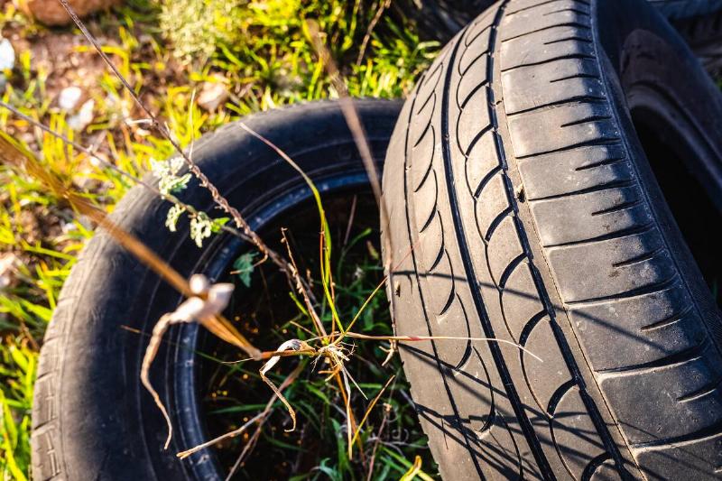 Old rubber tires in a field. 