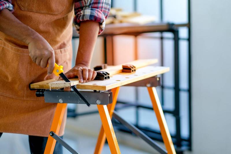 Craftsman working on a folding workbench. 