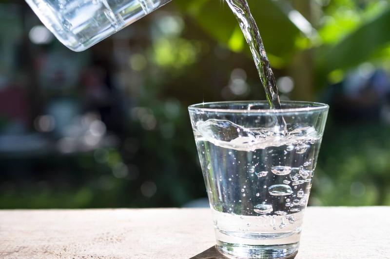 Pouring water into glass.