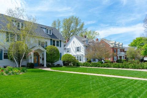 Suburban house with a bright green lawn.
