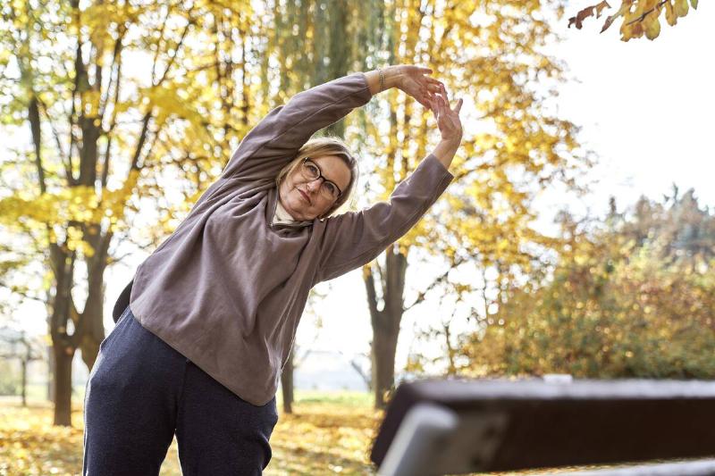 Woman stretching in fall. 
