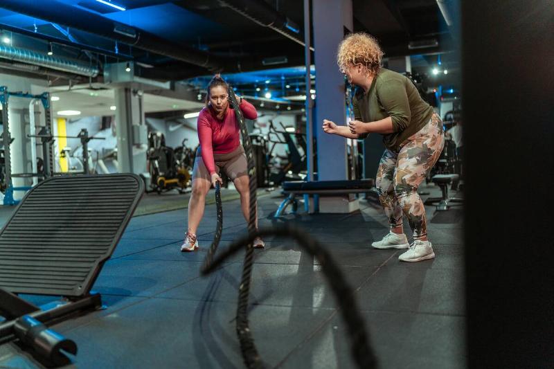 Two women working out in a gym.