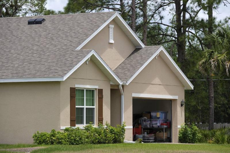 Front of house showing interior of garage.