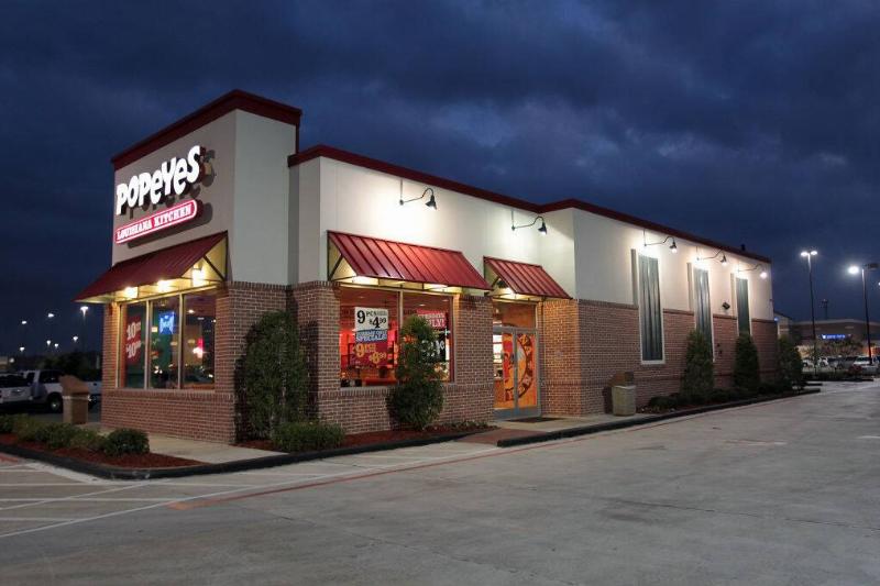 Exterior of a Popeyes restaurant at night