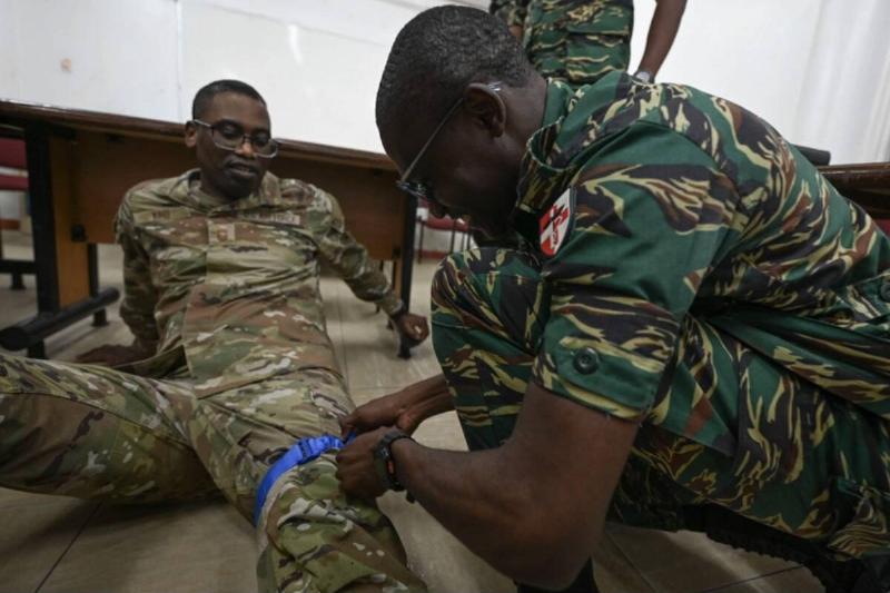 A Guyana Defence Force medic applies a tourniquet on Chief Master Sgt. Quami King, Andrew's Medical Group senior enlisted leader.