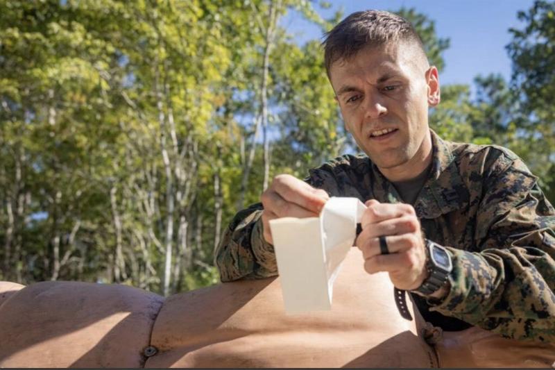 U.S. Marine Corps Capt. Tyler Carpenter administers a Bolin Chest Seal to a simulated casualty during the Division Leadership Assessment Program.