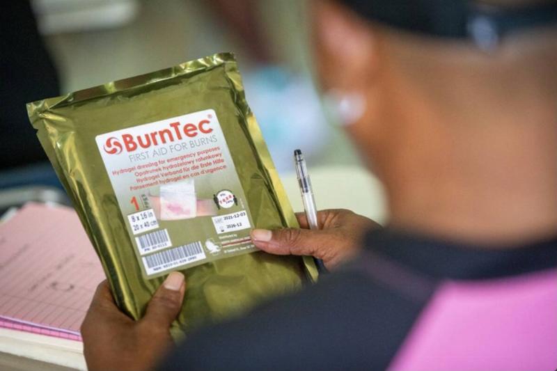 Man holding burn dressing package.