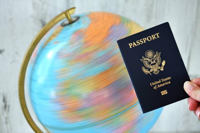 American passport in front of a spinning globe.