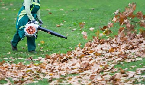 A person using a gas-powered leaf blower.