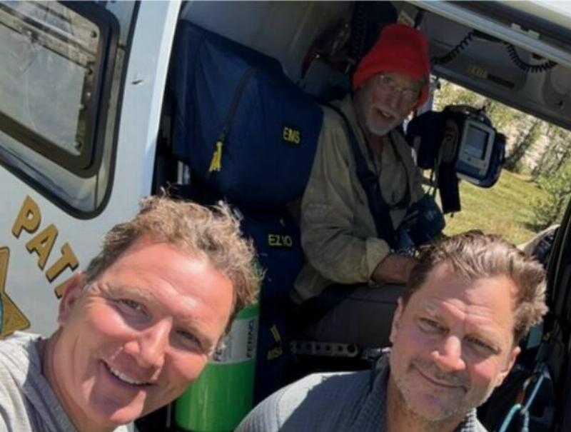 MJ and another scoutmaster seeing Montgomery off in the helicopter.