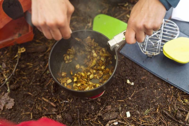 Close-up of person cooking food in forest