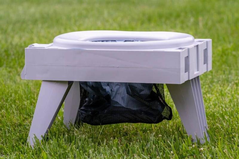 A small, plastic folding toilet.