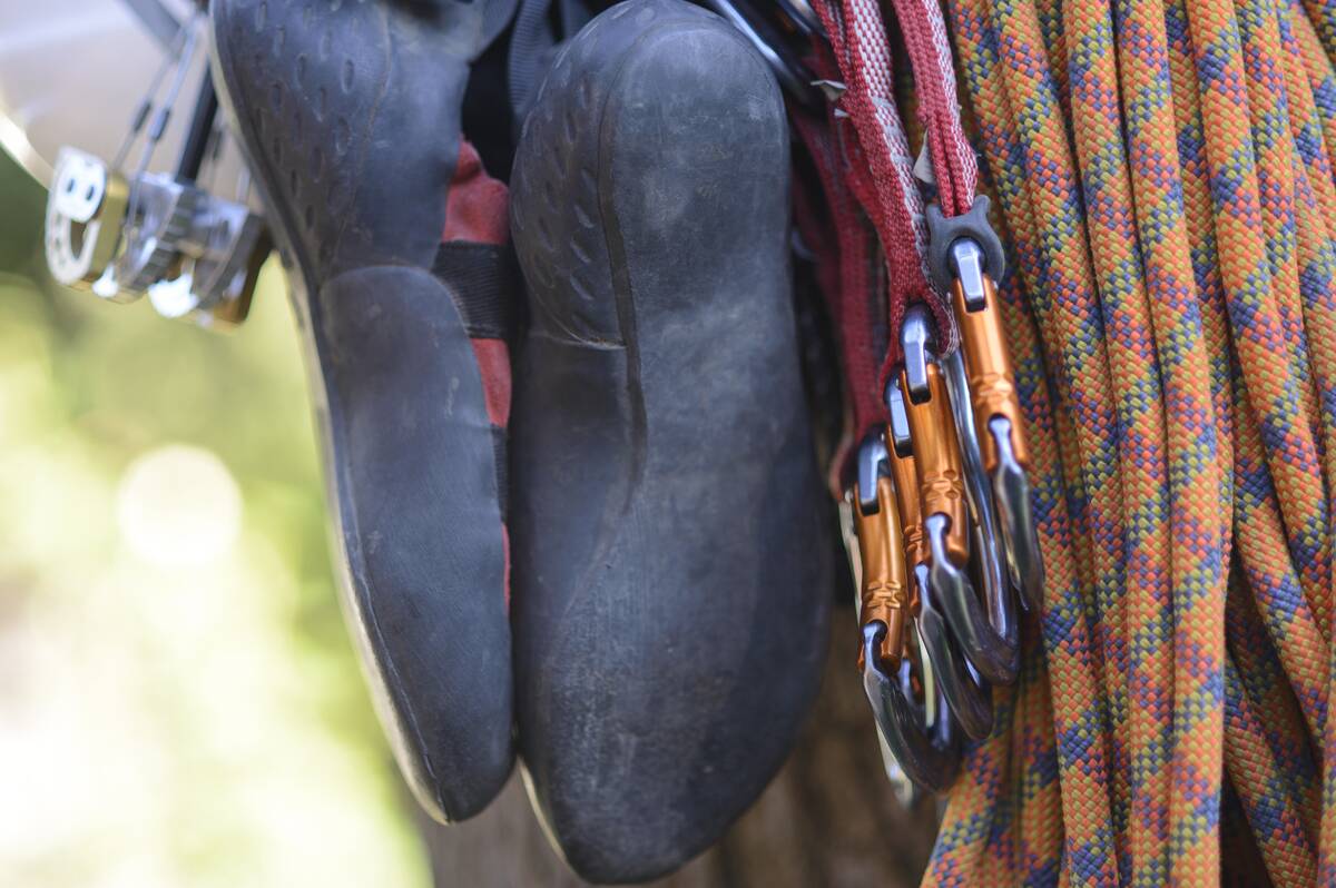 A pait of climbing shoes hung off a carabiner loop.