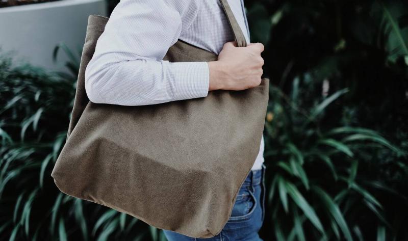 A woman with a tote bag over her shoulder.