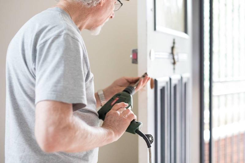 Man using drills to do home maintenance.
