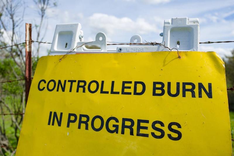 Close-up of sign reading Controlled Burn in Progress, warning visitors about use of the controlled burn forestry technique to prevent wildfires, at Tilden Regional Park in Berkeley, California, March 26, 2019.
