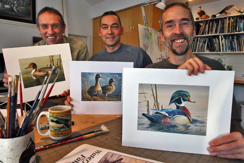 Brothers Joe, Bob and Jim Hautman have won the Federal Duck Stamp contest 10 times, with Joe the current recipient of the award. Here Bob Hautman, left, displayed his 2001 print winner, Jim Hautman, center, displayed his 2011 print winner, while Joe Hautman, right, displayed his 2012 print winner.