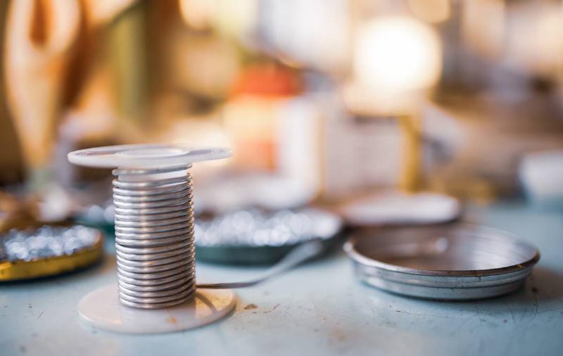 A small spool of wire on a workshop table.