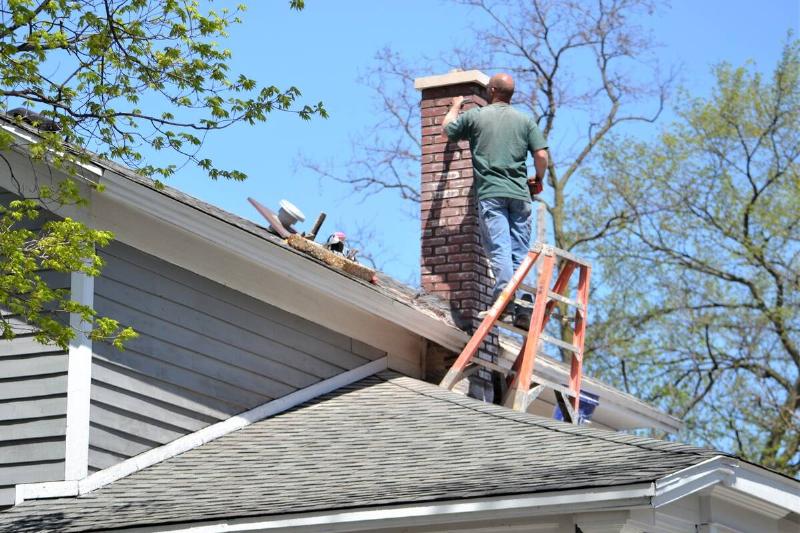 Man inspecting his chimney.