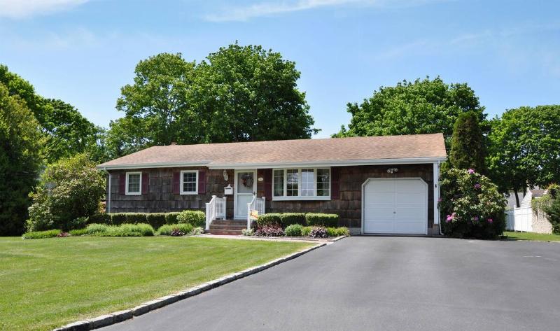 A home, the driveway lined with decorative brick.