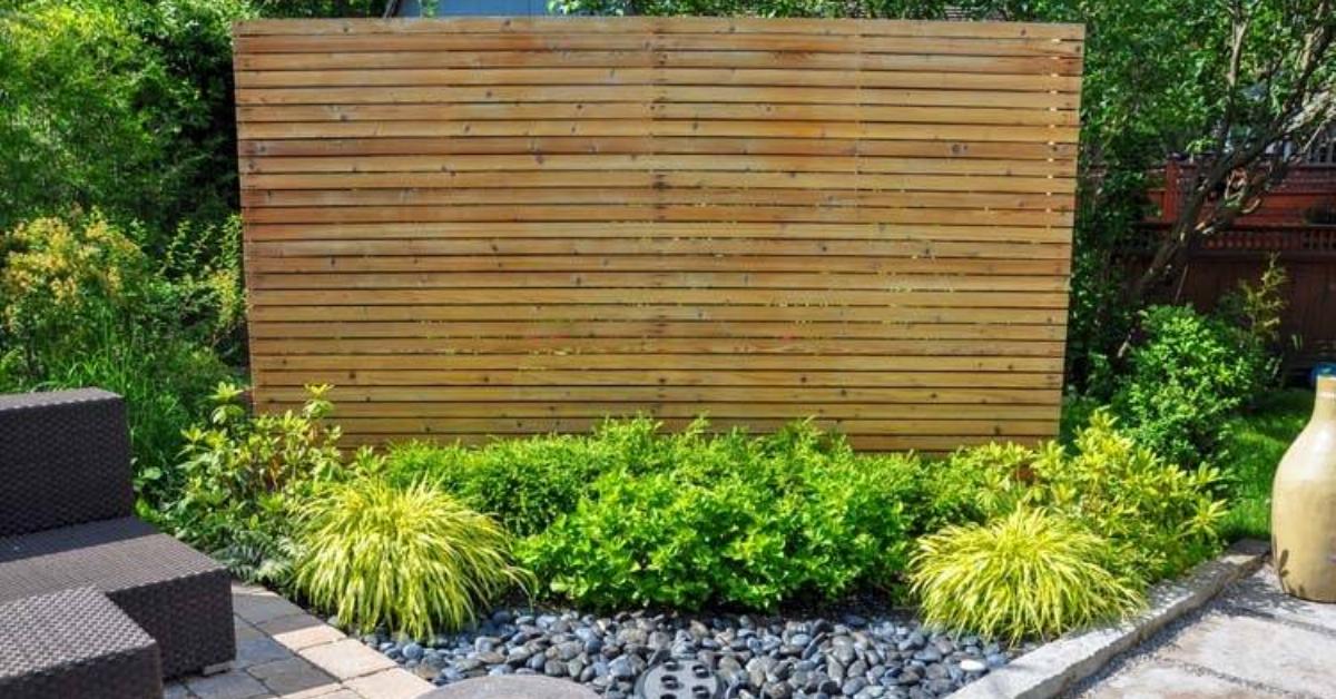 A large decorative wooden panel that's hiding a utility box.