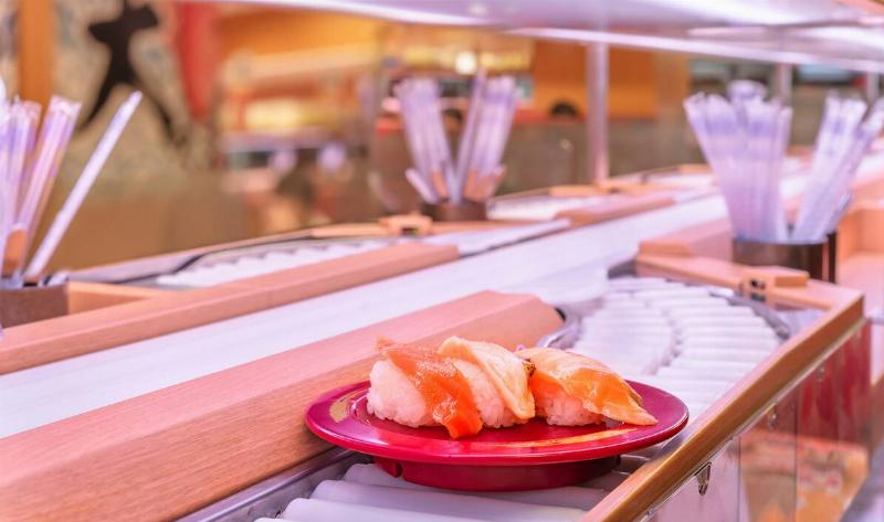 A plate of sushi on a conveyor at a conveyor restaurant.