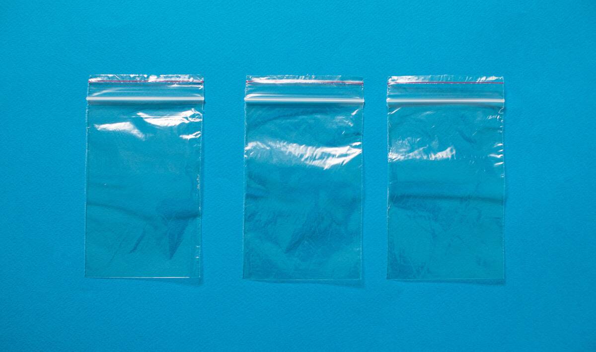 Three small ziploc bags against a blue background.