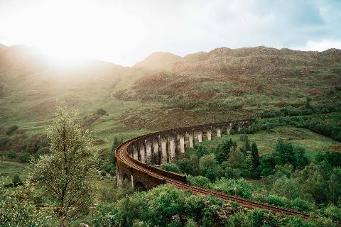 The famous Glenfinnan Viaduct in scenic highlands of Scotland on a sunny day