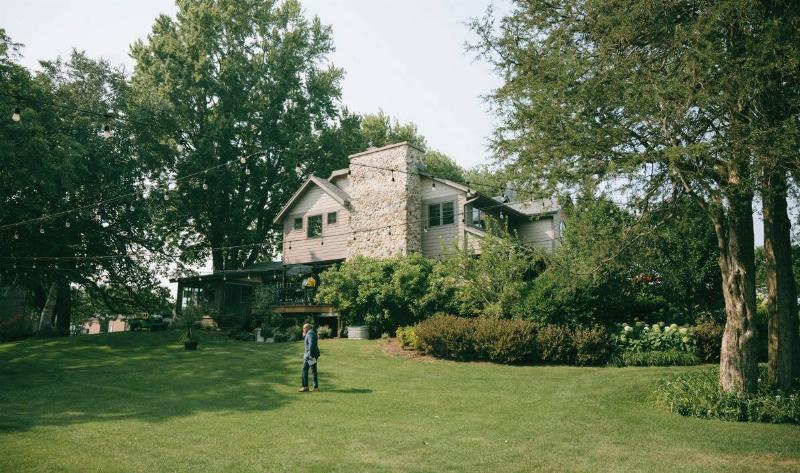A large backyard with multiple trees in different areas.
