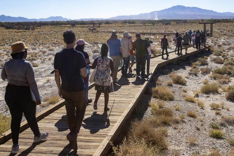 The Climate and Community Institute tour group, made up of workers and students learning about the effects of lithium mining, walks to Crystal Springs during a tour of the Ash Meadows National Wildlife Refuge, on Oct. 23, 2024, in Amargosa Valley, Nevada.