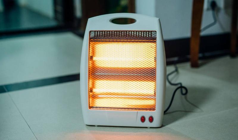 A small space heater on a tile floor.